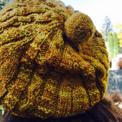 cabled knit hat improvised from the top down