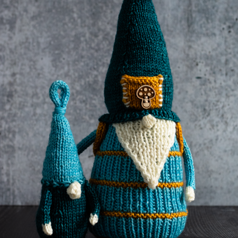 A big and little pair of knitted gnomes